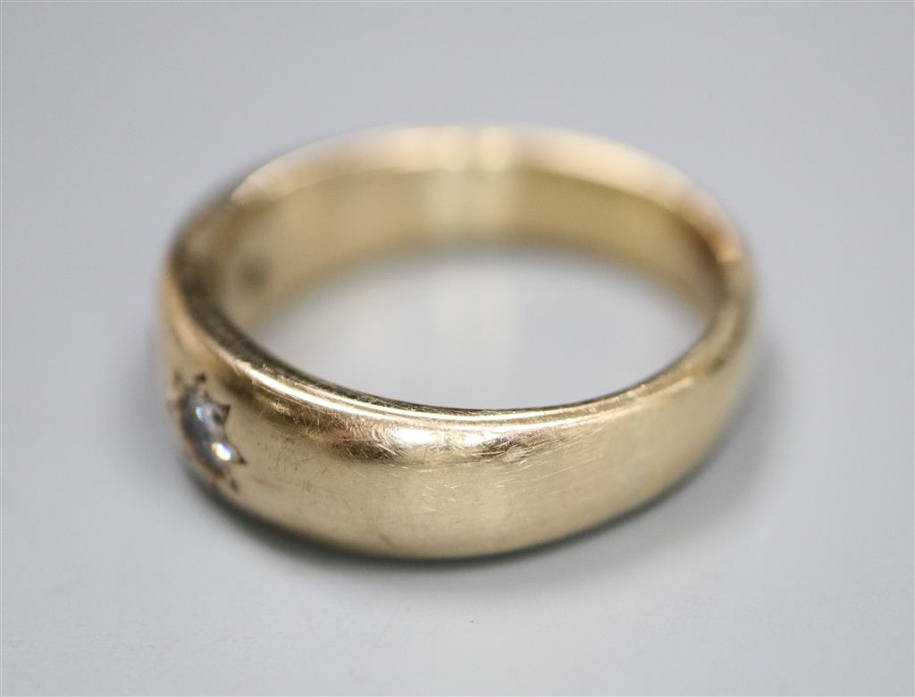 A yellow metal and gypsy set ruby and diamond three stone ring, size U/V, gross 8.9 grams.